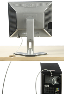 computer and monitor secured with a security cable looped through data hole in a desk